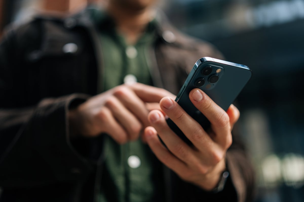 Person using a smartphone on a city street